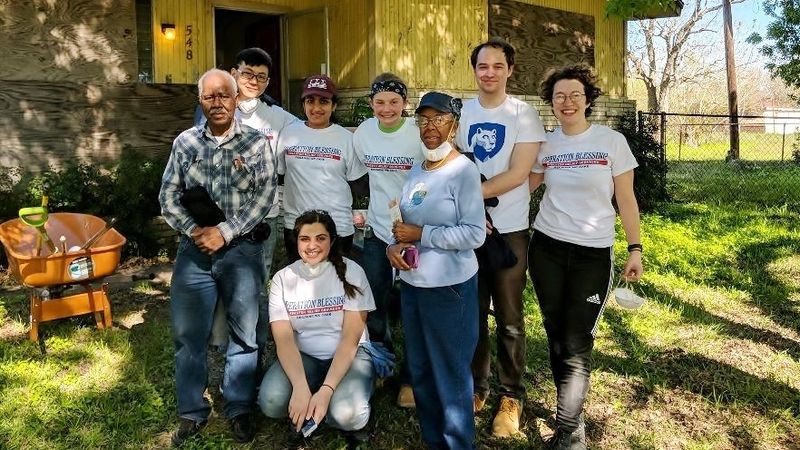 Penn State Behrend students pose with homeowners during a spring break service trip to Houston.