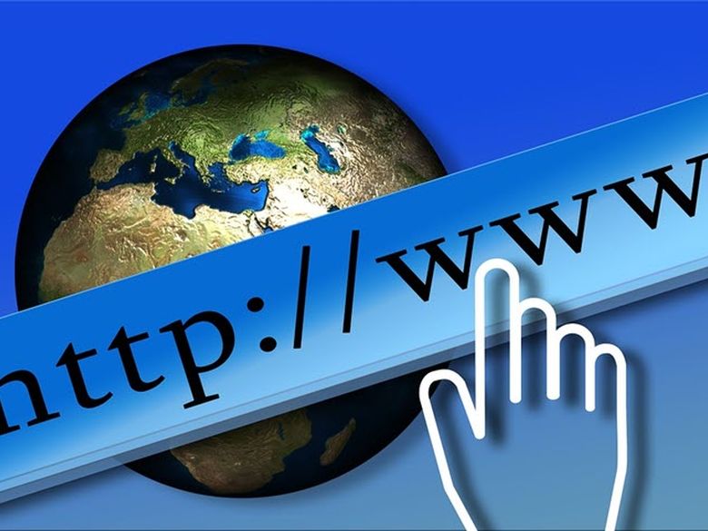 Hand pointing to http://www which overlays image of earth