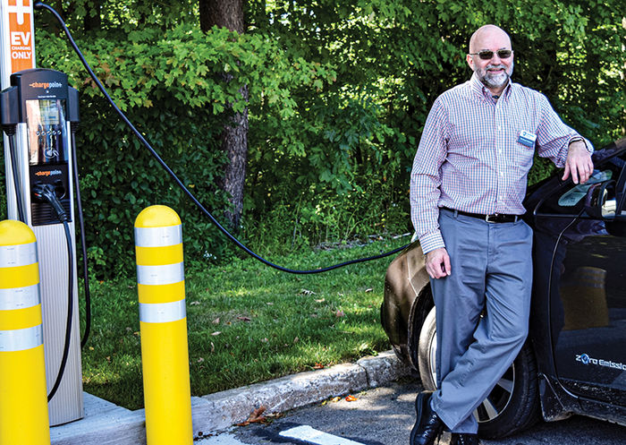 Dr. Michael Rutter, associate director of the School of Science, charges his electric vehicle at a charging station near the Science Complex.