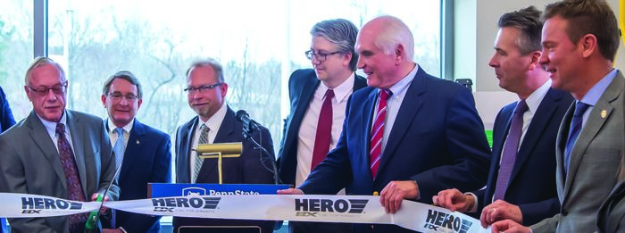 Pat Black, far left, founder and CEO of HERO BX, cuts the ribbon on the new biofuels research center in Knowledge Park. Black was joined by numerous government, industry, and Behrend officials, including Chancellor Ralph Ford, second from right, and Dr. Martin Kociolek, fourth from right, director of the School of Science.