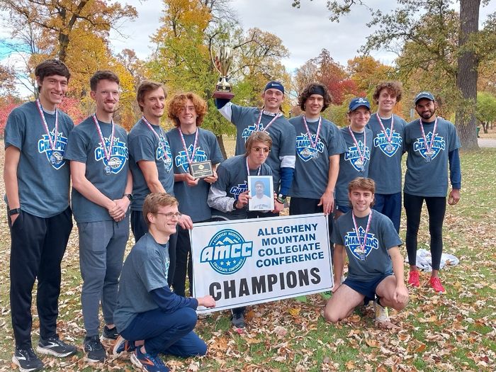 The Penn State Behrend men's cross country team poses with the AMCC championship banner.