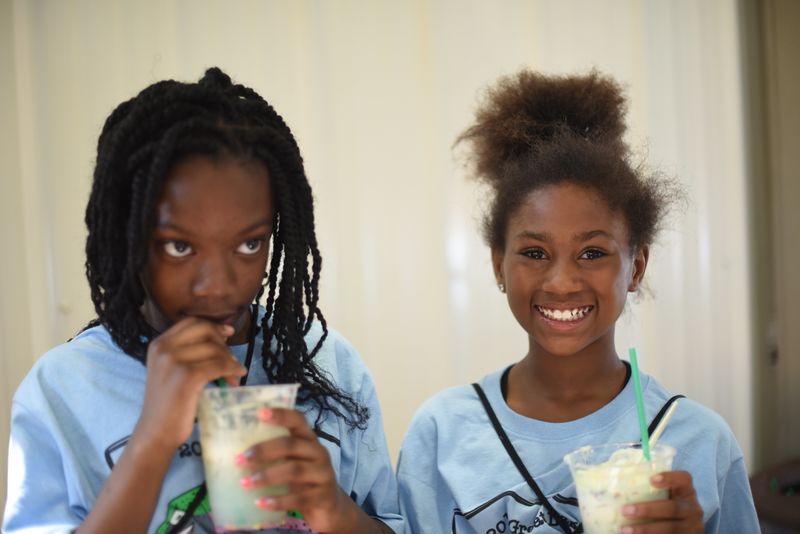 Denanyae Evans, left, and Diora Jones, both fifth-grade students at Pfeiffer-Burleigh School, posed with their edible aquifers.