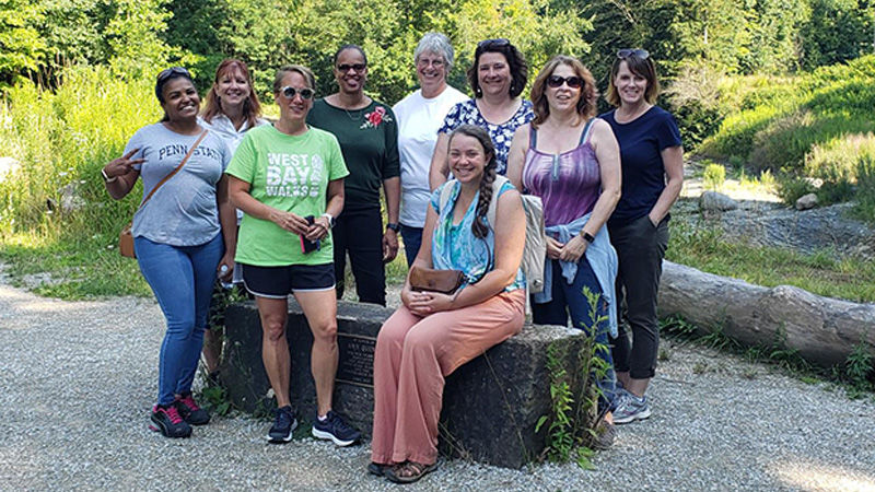 Group of women posting at the entrance to the Wintergreen Gorge Trail. 