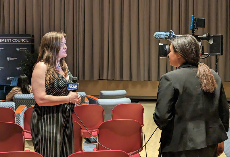 Student, Lauren Cass, is interviewed by TV reporter at Blue Chair chat