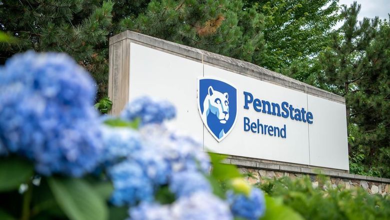 Flowers in front of the Penn State Behrend entrance sign