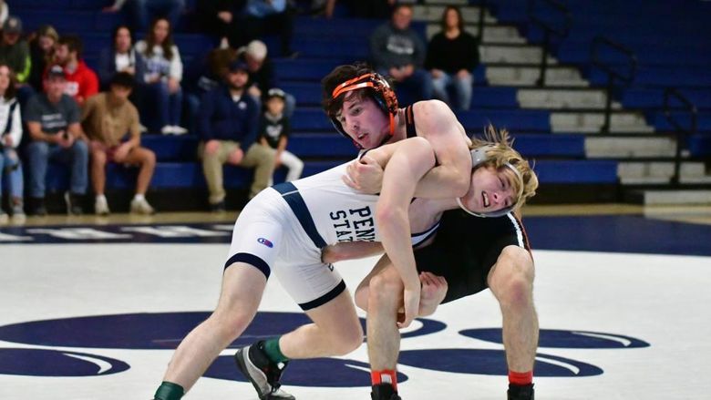 Two wrestlers grapple during a meet at Penn State Behrend.