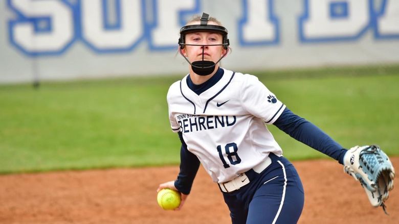 A pitcher for the Penn State Behrend softball team prepares to throw the ball.