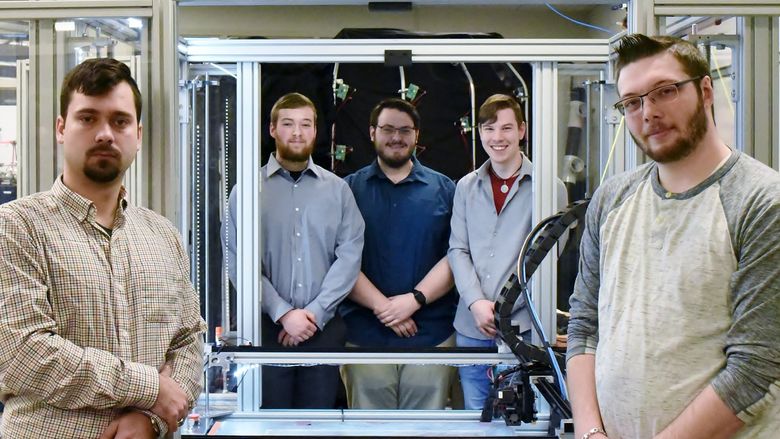John Nowakowski, far left, Ryan Hutchinson, Michael Gibilterra, Elijah Thompson and Mike Paul worked together to build a large-format 3D printer from scratch in Penn State Behrend's Innovation Commons.