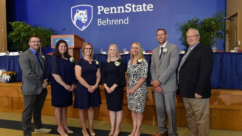 Alumni stand with Director of Athletics Brian Streeter at the Penn State Behrend Athletics Hall of Fame