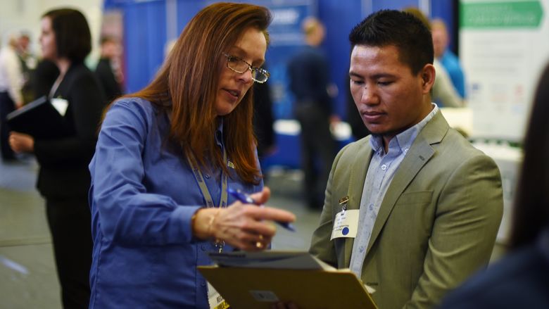 Bikash Subba, a senior mechanical engineering technology major, converses with an employer at Penn State Behrend's spring Career and Internship Fair, held March 16 at the college.