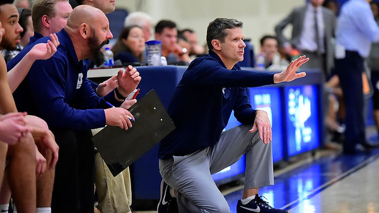 Penn State Behrend basketball coach Dave Niland offers instructions from courtside.