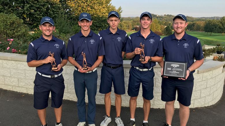 Members of the Penn State Behrend golf team pose with trophies after winning the La Roche Fall Invitational.