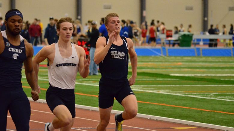 A Penn State Behrend runner competes in an indoor race.