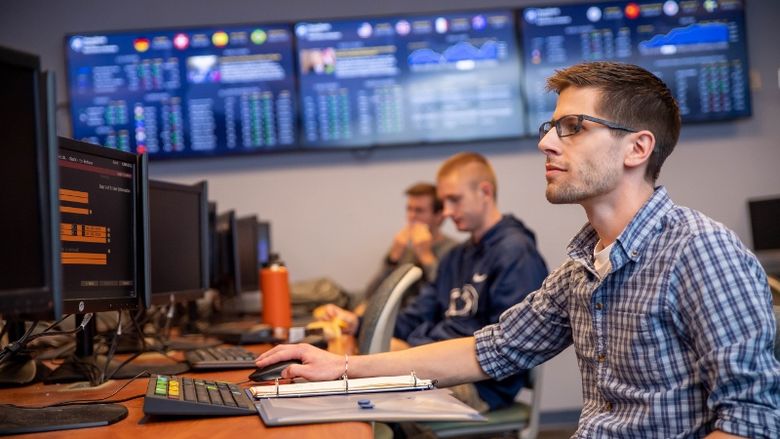 Students work at Bloomberg Terminals in Penn State Behrend's finance lab.