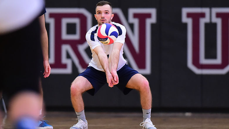 Penn State Behrend volleyball player Robert McMaster prepares to hit the ball.