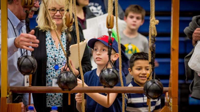 A child experiments with pulleys at the Penn State Behrend STEAM fair.