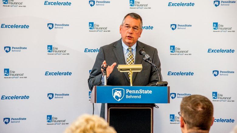 Erie Insurance Group President and CEO Tim NeCastro speaks at a podium during an announcement program for a new partnership with Penn State Behrend.