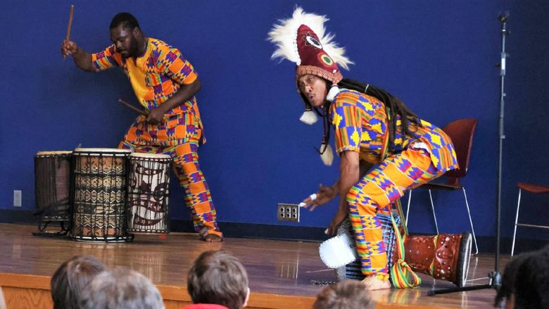 Two drummers perform traditional African music at Penn State Behrend's McGarvey Commons.