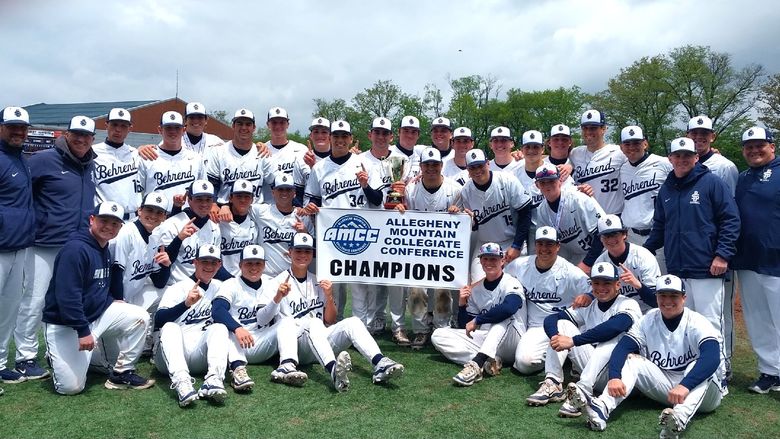 The Penn State Behrend baseball team poses with the AMCC championship banner.