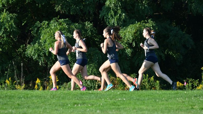Five cross country runners advance through a course at Penn State Behrend.