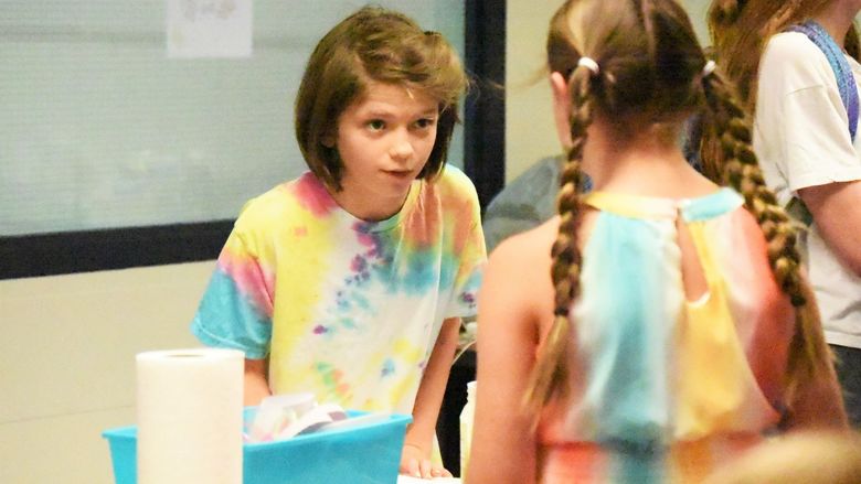 A 12-year-old girl interviews another student during a Penn State Behrend College for Kids program.