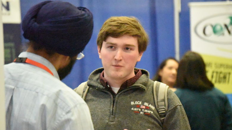 A student talks with a recruiter at Penn State Behrend's spring Career and Internship Fair.