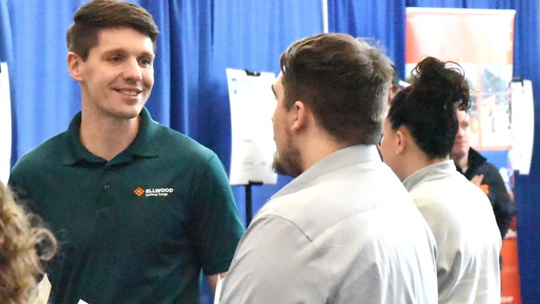 A recruiter for Ellwood National Forge talks with students at Penn State Behrend's career fair.