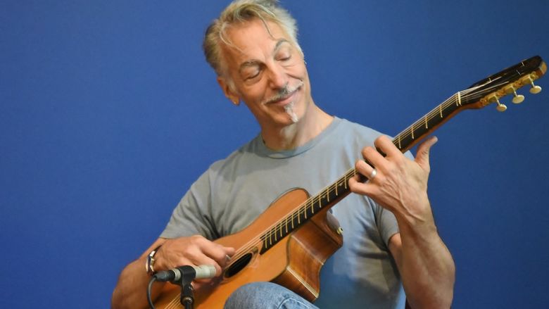 A guitarist performs during Music at Noon: The Logan Series at Penn State Behrend.