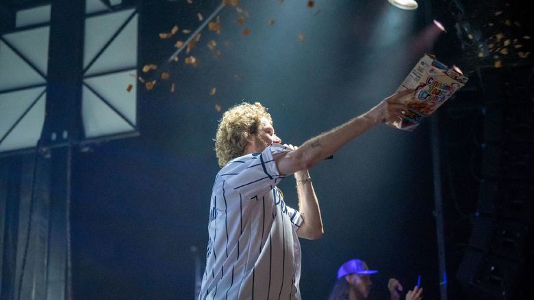 The rapper Yung Gravy throws cereal onto the crowd during the student concert at Penn State Behrend.