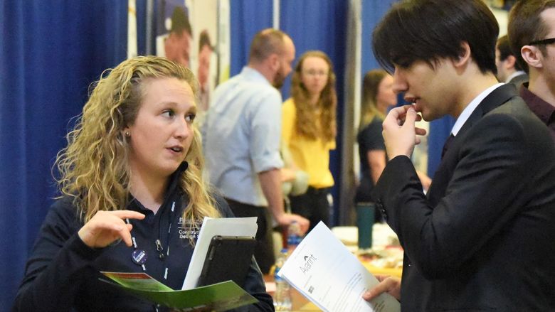 A recruiter talks with a student at Penn State Behrend's spring Career and Internship Fair.