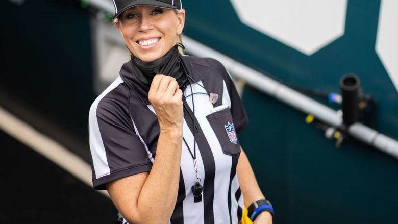 Sarah Thomas, the first female NFL official, on the field during a game.