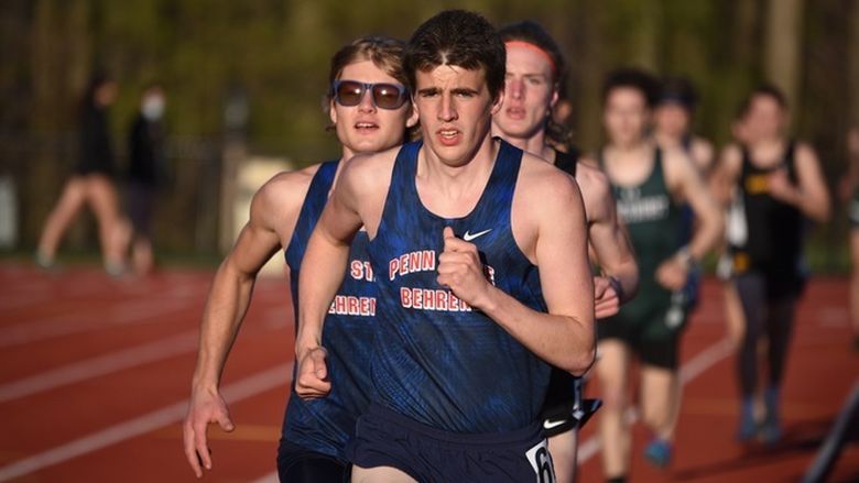 Two Penn State Behrend runners lead the pack in an outdoor track race.
