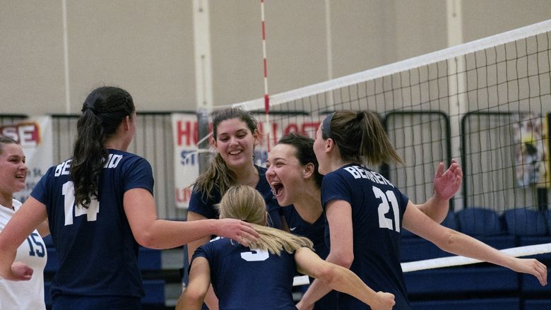 Members of the Penn State Behrend women's volleyball team celebrate a victory.