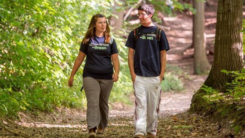 Two students walk in Wintergreen Gorge at Penn State Behrend.