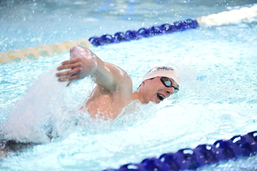 A Penn State Behrend swimmer competes in a freestyle event.