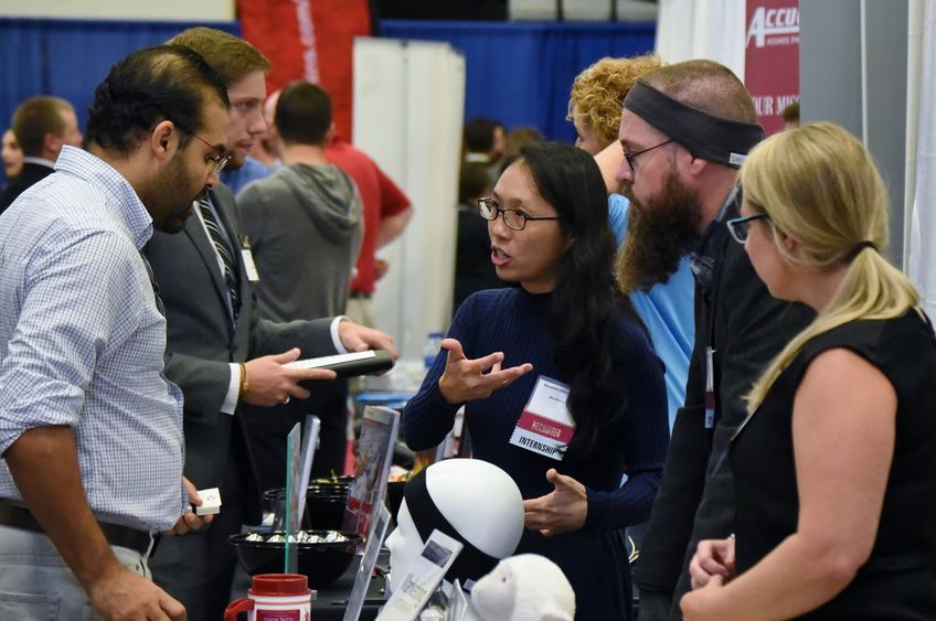 AcousticSheep LLC CEO Wei-Shin Lai, center, meets with a student during Penn State Behrend's Fall Career and Internship Fair, held Sept. 19 at the college.