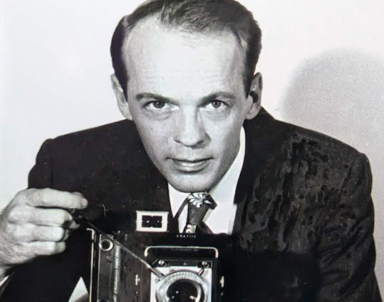 A portrait of Norman B. "Bill" Patterson with his camera