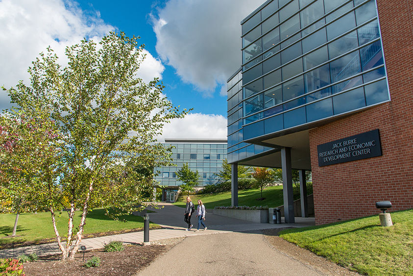 Two students walk in front of the Burke Center at Penn State Behrend.