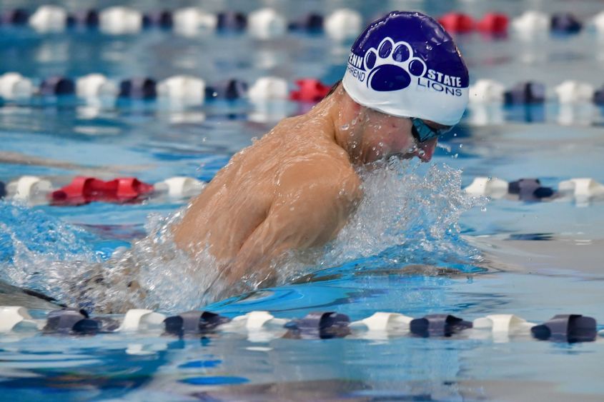 A Penn State Behrend swimmer competes in a breaststroke race.