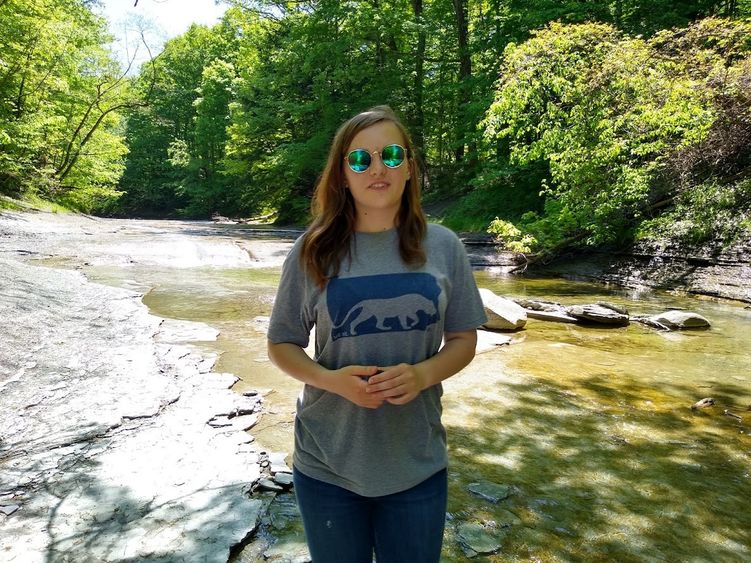 Penn State Behrend student Lauren Cass walks along the creek in Wintergreen Gorge.