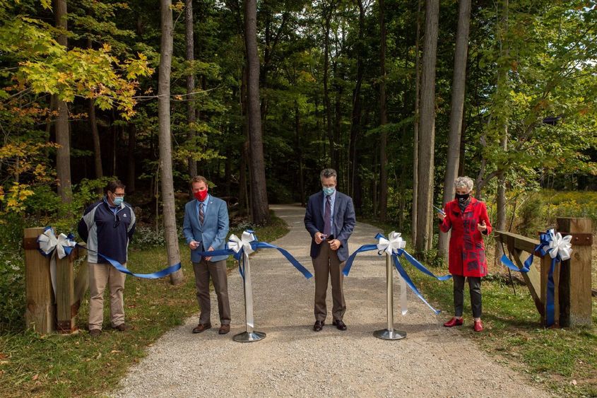 Four guests cut a dedication ribbon on a Wintergreen Gorge trail.