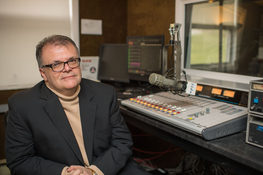 Joe Martin, the general manager of WPSE radio at Penn State Behrend, sits in the station's control room