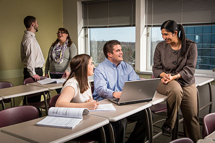 Four students talk with an instructor in Penn State Behrend's Master of Professional Accounting degree program.