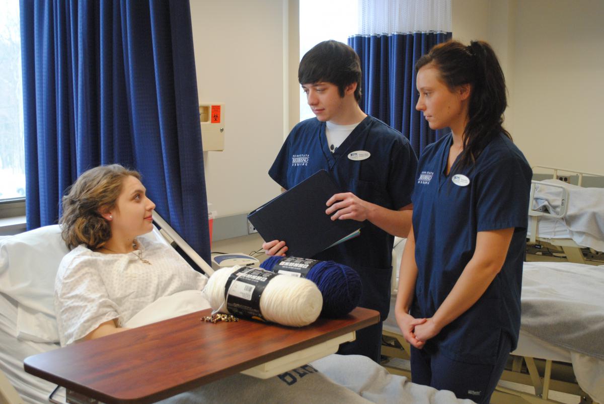 Brenna Lanager played the role of an elderly patient this past fall in a NURS 112 class. Students Hunter Olsen and Nerissa Rich were tasked with trying to prepare Lanager for surgery as part of the simulation.