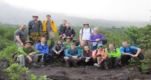 A group of students participates in a sustainability project outdoors