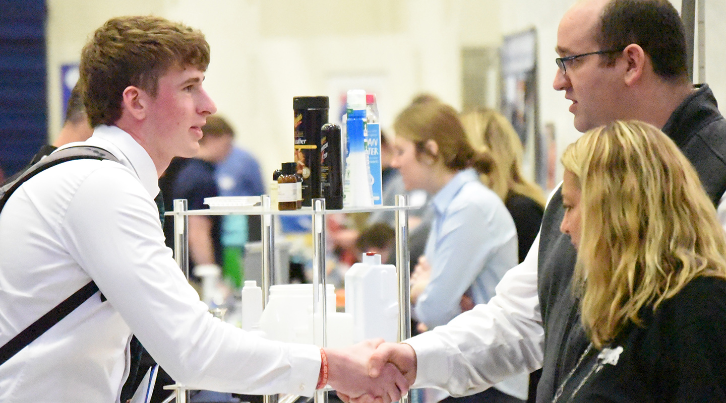 A student shaking hands with a potential employer
