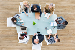 Aerial photo of business people sitting around a conference table