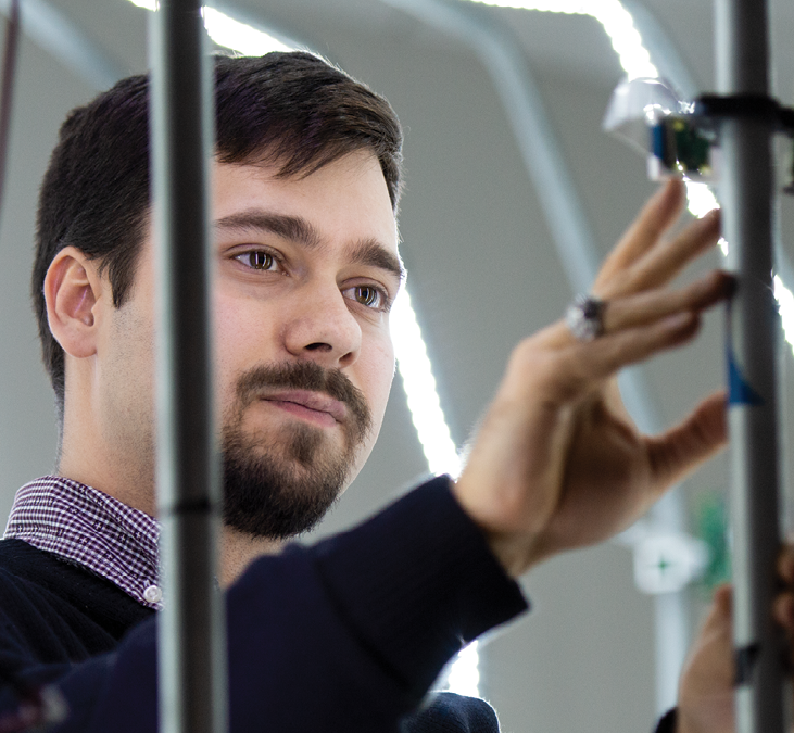 A male student uses the large-scale 3D scanner at the Penn State Behrend Innovation Commons