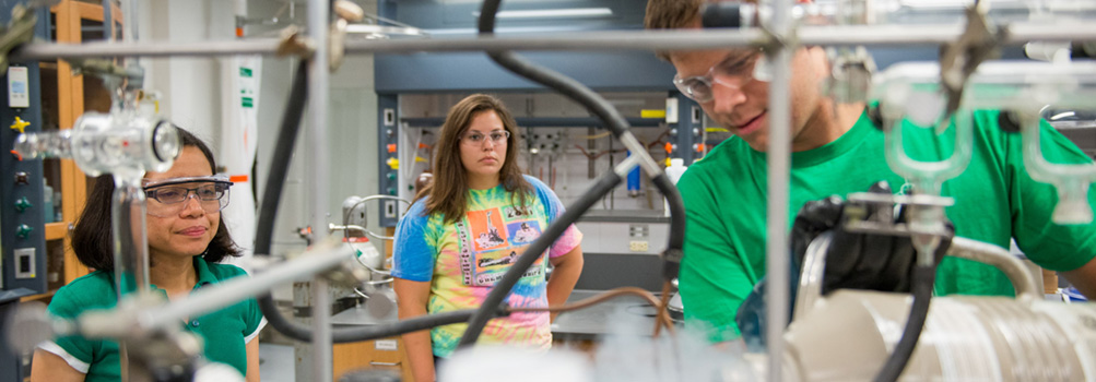 Students at Penn State Behrend work with a faculty member on a chemistry lab experiment.