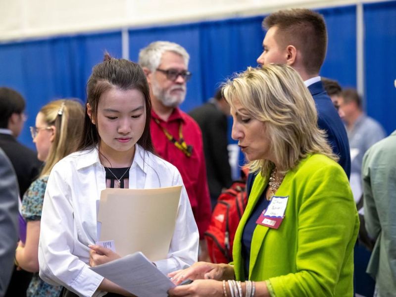 A Penn State Behrend student talks with a recruiter at the college's Career and Internship Fair.